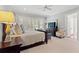 Main bedroom with decorative furniture, a ceiling fan and large windows providing natural light at 14 Royal Beach Dr, Kiawah Island, SC 29455
