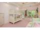 Charming bedroom featuring pink carpet, bright light, and a bunkbed with a window seat overlooking lush greenery at 14 Royal Beach Dr, Kiawah Island, SC 29455
