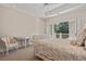 A bright bedroom featuring white furniture, French doors, and a lovely balcony view at 14 Royal Beach Dr, Kiawah Island, SC 29455