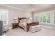 Comfortable bedroom with a ceiling fan, neutral walls, and window shutters at 14 Royal Beach Dr, Kiawah Island, SC 29455