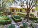 Charming home with landscaped front yard, manicured bushes, and inviting entryway at 14 Royal Beach Dr, Kiawah Island, SC 29455