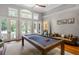 Bright game room with pool table and beautiful french doors to outside patio at 14 Royal Beach Dr, Kiawah Island, SC 29455