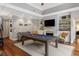 Spacious game room with a pool table, fireplace, and built-in shelving at 14 Royal Beach Dr, Kiawah Island, SC 29455