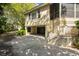 Home's exterior shows the two-car garage with steps leading to a screened-in porch at 14 Royal Beach Dr, Kiawah Island, SC 29455