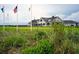 Picturesque golf course with clubhouse featuring manicured greens and waving flags in foreground at 14 Royal Beach Dr, Kiawah Island, SC 29455