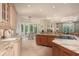 Spacious kitchen with wooden cabinets, stone countertops, and tiled floor at 14 Royal Beach Dr, Kiawah Island, SC 29455