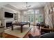 Spacious living room with fireplace, pool table, and large windows at 14 Royal Beach Dr, Kiawah Island, SC 29455