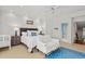 Bright main bedroom featuring wainscoting, plush bedding and stylish decor with an attached bathroom at 14 Royal Beach Dr, Kiawah Island, SC 29455