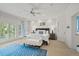 A serene main bedroom has a calming white palette and ample natural light from the windows at 14 Royal Beach Dr, Kiawah Island, SC 29455