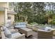 Outdoor patio boasts a hot tub, grill, comfortable seating and wooded view at 14 Royal Beach Dr, Kiawah Island, SC 29455