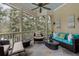 Relaxing screened-in porch with comfortable seating and ceiling fan at 14 Royal Beach Dr, Kiawah Island, SC 29455