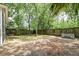 Backyard showcasing a wooden fence, mature trees, and a grass lawn at 1453 Joy Ave, Charleston, SC 29407