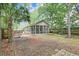A screened patio in a yard is visible near trees and a palm tree at 1453 Joy Ave, Charleston, SC 29407