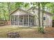 The back of the house and a screened in patio is visible in the backyard at 1453 Joy Ave, Charleston, SC 29407