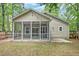 Backyard showcasing a screened-in porch and a well-maintained lawn at 1453 Joy Ave, Charleston, SC 29407