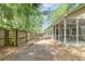 Large fenced backyard featuring a screened porch, fire pit and wooded views at 1453 Joy Ave, Charleston, SC 29407