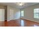 Spacious bedroom with two windows, hardwood flooring, a ceiling fan, and a neutral color scheme for a relaxing feel at 1453 Joy Ave, Charleston, SC 29407