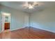 Bedroom featuring hardwood flooring, a ceiling fan, and a door that leads into an adjoining bathroom at 1453 Joy Ave, Charleston, SC 29407