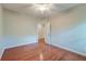 This bedroom with hardwood flooring, ceiling fan, and an open doorway to a well-lit adjacent space at 1453 Joy Ave, Charleston, SC 29407