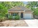 Inviting single-Gathering home with a quaint front porch, manicured landscaping, and an attached one-car garage at 1453 Joy Ave, Charleston, SC 29407