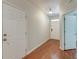 Bright hallway with hardwood floors features a view of the front door and access to other rooms in the house at 1453 Joy Ave, Charleston, SC 29407