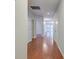 Well-lit hallway with beautiful hardwood floors and white doors leading to various rooms in the home at 1453 Joy Ave, Charleston, SC 29407