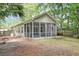 View of the screened in porch and yard featuring mature trees and landscaping at 1453 Joy Ave, Charleston, SC 29407