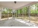 The screened porch overlooks a private backyard with views of trees, perfect for enjoying the outdoors at 1453 Joy Ave, Charleston, SC 29407