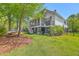 Spacious backyard with green grass, trees, and a hammock; great for outdoor recreation and relaxation at 1535 Capel St, Mount Pleasant, SC 29466