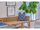 Stylish wicker bench with blue floral pillow and live tree sits against a blue floral wallpaper at 1535 Capel St, Mount Pleasant, SC 29466