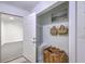 Mudroom closet area featuring white door, custom shelving, and storage baskets for a functional space at 1535 Capel St, Mount Pleasant, SC 29466