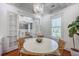 Elegant dining space with chandelier, French doors, and hardwood floors with table and chairs at 1535 Capel St, Mount Pleasant, SC 29466