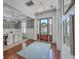 Inviting entryway with a beautiful wood door, modern light fixture, and hardwood floors at 1535 Capel St, Mount Pleasant, SC 29466