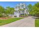 Charming two-story home with double porches, white trim, and lush landscaping at 1535 Capel St, Mount Pleasant, SC 29466