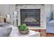 Close-up of the fireplace with marble surround, decorative accents, and hardwood floors at 1535 Capel St, Mount Pleasant, SC 29466