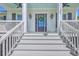 Welcoming front entrance features white stairs, a dark door with wreath, and stylish exterior lighting at 1535 Capel St, Mount Pleasant, SC 29466