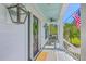 Charming front porch with rocking chairs, elegant lights, and a view of the manicured lawn at 1535 Capel St, Mount Pleasant, SC 29466