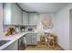 Stylish kitchen boasts modern appliances, light blue cabinets, a breakfast nook, and beautiful white countertops at 1535 Capel St, Mount Pleasant, SC 29466