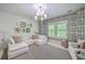 Bright living room with comfortable seating, patterned wallpaper, and natural light at 1535 Capel St, Mount Pleasant, SC 29466