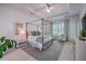 Spacious bedroom with a four-poster bed, tray ceiling, and a seating area at 1535 Capel St, Mount Pleasant, SC 29466