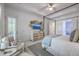 Main bedroom features a four poster bed, a dresser with TV and a sunny seating area at 1535 Capel St, Mount Pleasant, SC 29466