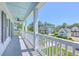 Wide porch offering neighborhood views, showcasing bright houses under a clear blue sky at 1535 Capel St, Mount Pleasant, SC 29466