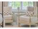 Bedroom sitting area features patterned chairs, a side table, and large windows at 1535 Capel St, Mount Pleasant, SC 29466
