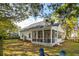 Picturesque backyard featuring a screened porch, lush lawn, and comfortable seating at 1543 Gemstone Dr, Mount Pleasant, SC 29464