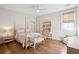 Bedroom with hardwood floors, ceiling fan, window, bench, and a desk at 1543 Gemstone Dr, Mount Pleasant, SC 29464