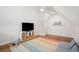 Bonus room with sloped ceilings, hardwood floors, and a television with toy storage at 1543 Gemstone Dr, Mount Pleasant, SC 29464