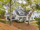 Charming two-story home with a manicured front yard, inviting porch, and mature trees at 1543 Gemstone Dr, Mount Pleasant, SC 29464