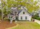 Charming two-story home featuring a manicured lawn, a large tree, and a welcoming blue front door at 1543 Gemstone Dr, Mount Pleasant, SC 29464