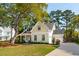 Inviting home boasting a lush lawn, mature shade trees, and an attached two-car garage at 1543 Gemstone Dr, Mount Pleasant, SC 29464