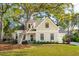 Charming home featuring a well-manicured lawn, mature trees, and a welcoming front porch at 1543 Gemstone Dr, Mount Pleasant, SC 29464